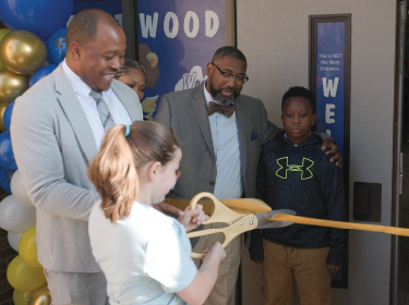 student and administrator at ribbon cutting
